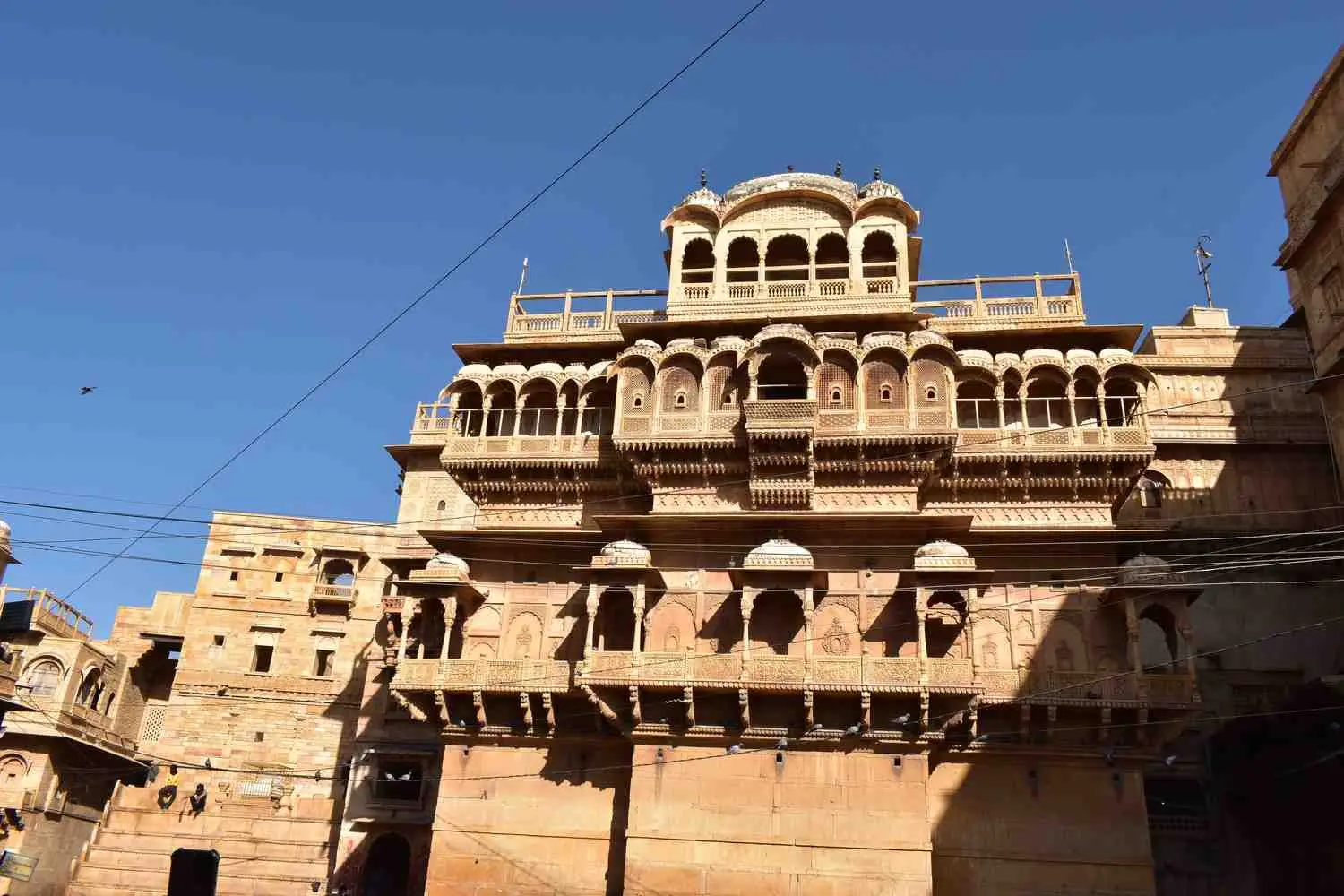 Ornate carved balconies of a golden sandstone haveli